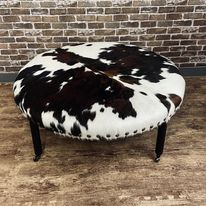 round center table with animal skin upholstery